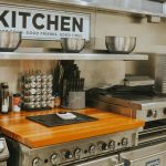 a kitchen with stainless steel appliances and a wooden counter