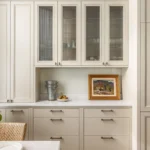 Warm neutral kitchen with light wood cabinets and island