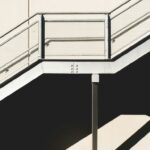 white metal stairs beside concrete wall