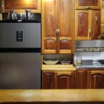 a kitchen with wooden cabinets and a metallic refrigerator