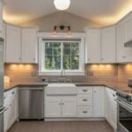 white wooden kitchen cabinet with white pendant lamp