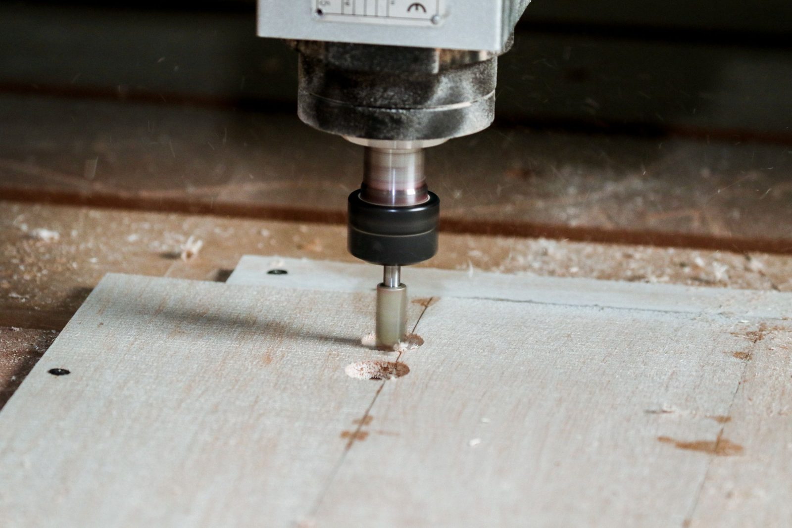 CNC machine drilling holes in a cabinet panel